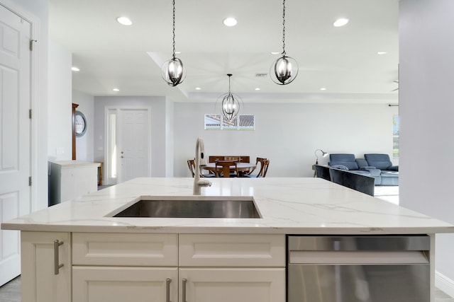 kitchen with recessed lighting, open floor plan, a sink, and stainless steel dishwasher