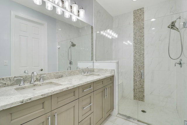 bathroom with a stall shower, marble finish floor, a sink, and double vanity