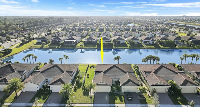 bird's eye view featuring a water view and a residential view