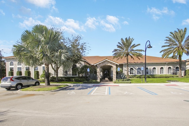 view of building exterior with uncovered parking