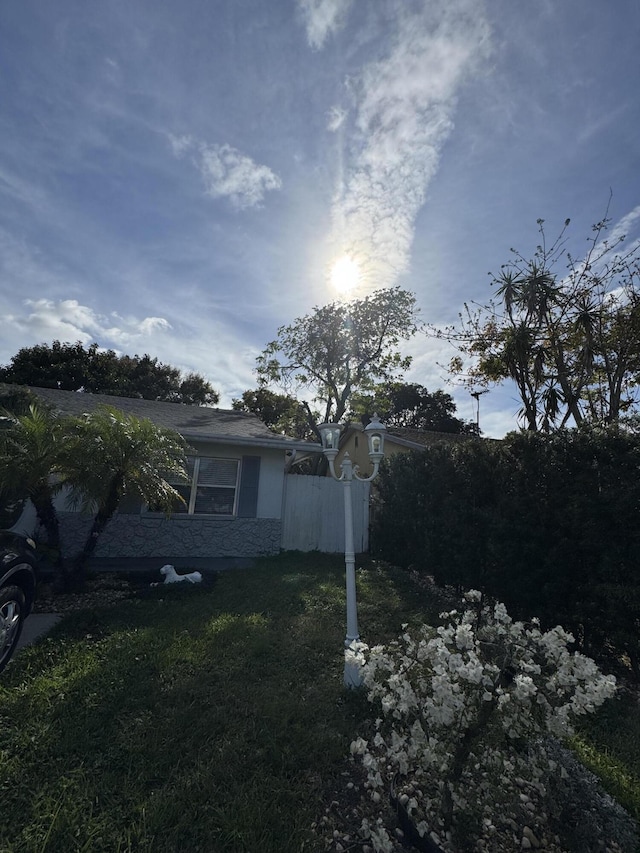 view of side of property with a lawn