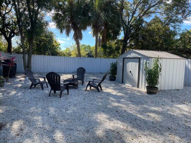 view of yard with a fire pit and a shed