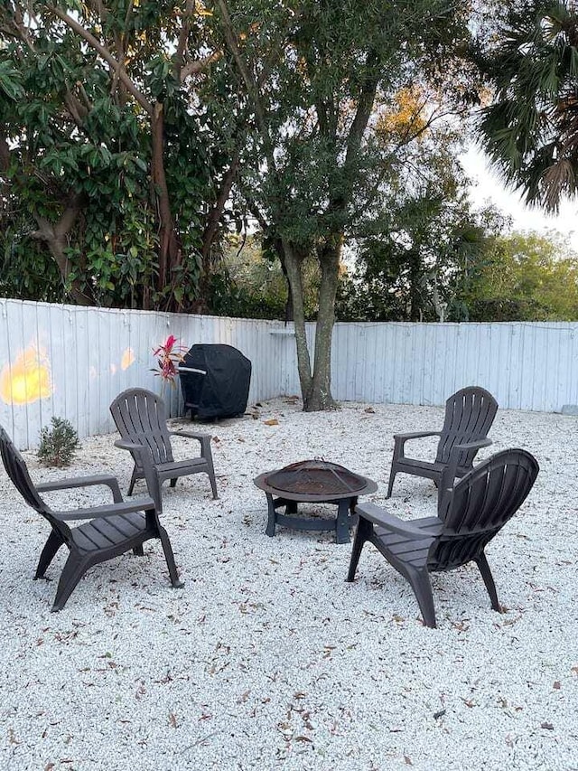 view of patio with a grill and an outdoor fire pit