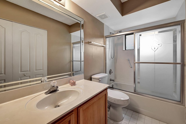 full bathroom with tile patterned flooring, vanity, toilet, and bath / shower combo with glass door