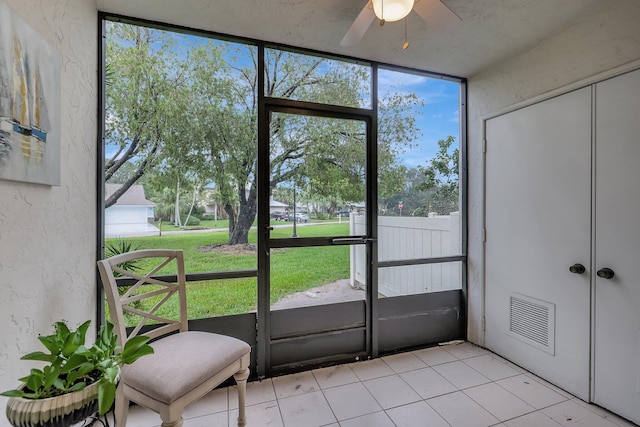 doorway with ceiling fan