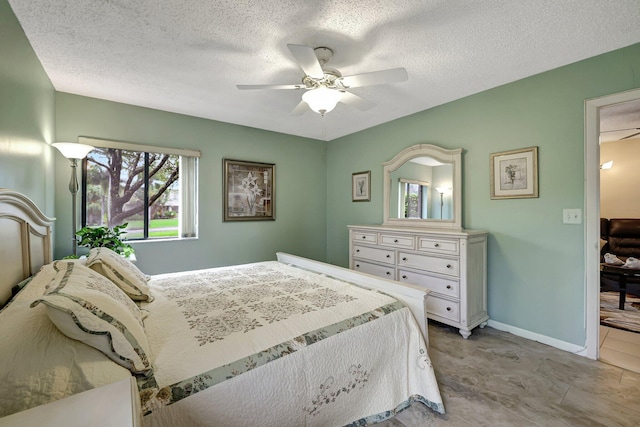 bedroom with ceiling fan and a textured ceiling