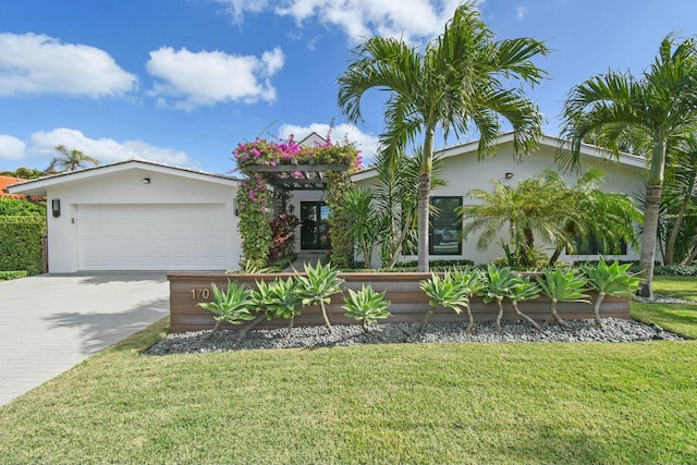 view of front of home featuring a front lawn and a garage