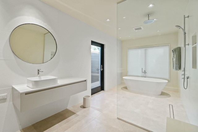 bathroom featuring tile patterned flooring, shower with separate bathtub, and vanity