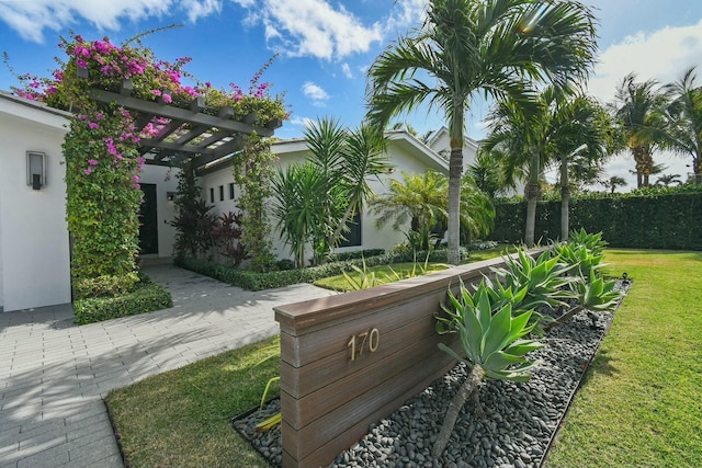 surrounding community with a pergola and a lawn