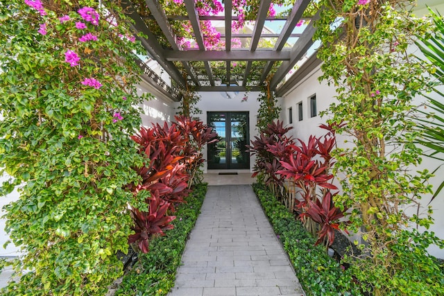 entrance to property featuring french doors and a pergola