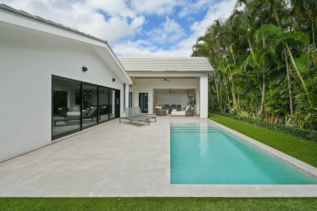 view of swimming pool featuring ceiling fan, a patio, and an outdoor hangout area