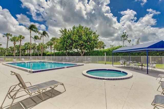 view of pool with a patio area and a hot tub