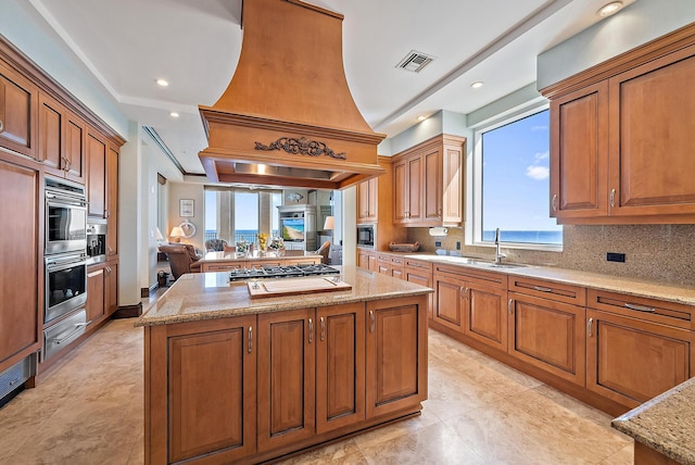 5310 N Ocean Dr Unit Ph-1201, Singer Island, FL 33404 - kitchen with visible vents, a kitchen island, custom exhaust hood, stainless steel appliances, and a sink