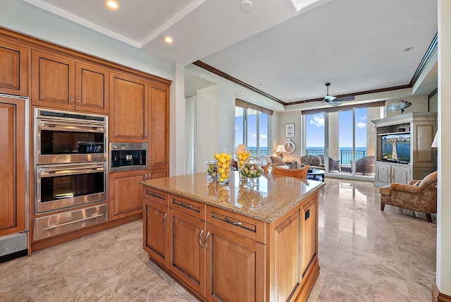 5310 N Ocean Dr Unit Ph-1201, Singer Island, FL 33404 - kitchen with light stone counters, a kitchen island, double oven, a warming drawer, and open floor plan