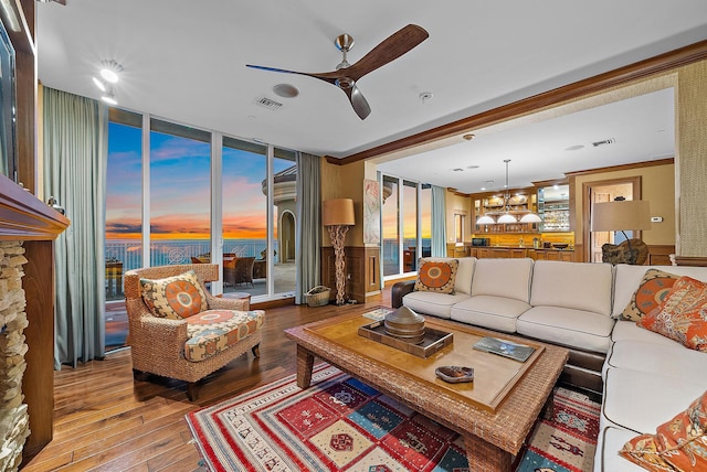 5310 N Ocean Dr Unit Ph-1201, Singer Island, FL 33404 - living area with floor to ceiling windows, ceiling fan with notable chandelier, visible vents, and wood-type flooring