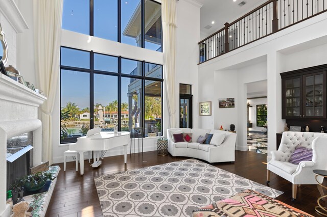 dining area with a notable chandelier, dark hardwood / wood-style flooring, and a high ceiling