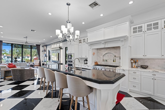 kitchen with crown molding, sink, white cabinets, and stainless steel appliances