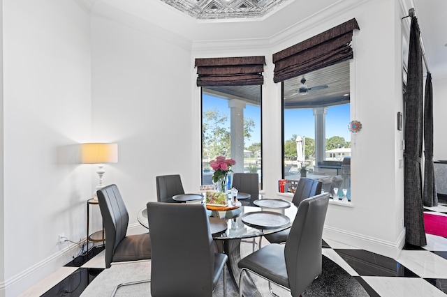 dining space featuring ceiling fan and ornamental molding