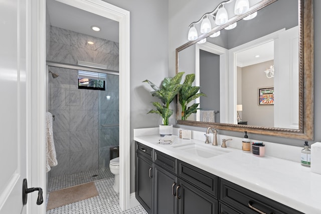 bathroom featuring vanity, a shower with shower door, and toilet