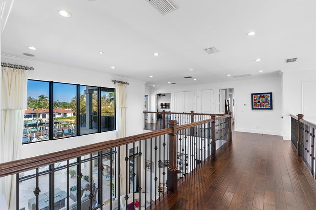 hallway featuring dark hardwood / wood-style floors, crown molding, and french doors