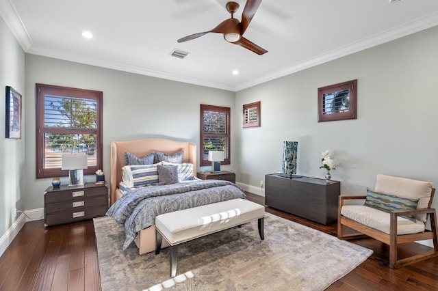 bedroom featuring dark hardwood / wood-style flooring, ceiling fan, and ornamental molding