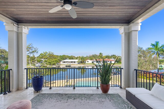 balcony with a water view and ceiling fan