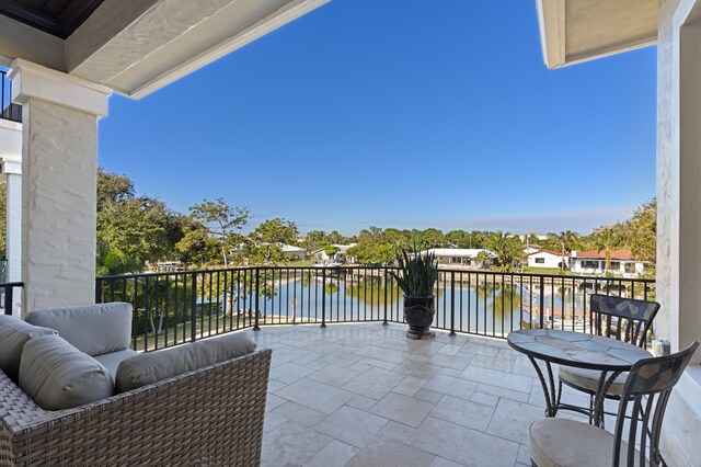 view of patio with an outdoor living space, ceiling fan, a balcony, and exterior kitchen