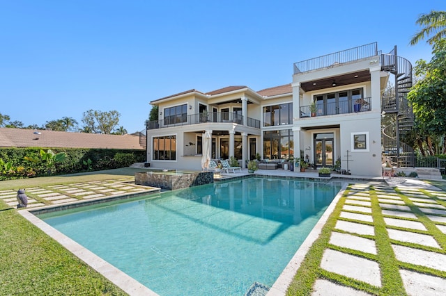 back of house with ceiling fan, a balcony, a patio, and french doors