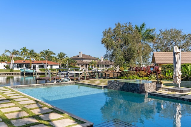 view of swimming pool featuring an in ground hot tub, a boat dock, and a water view