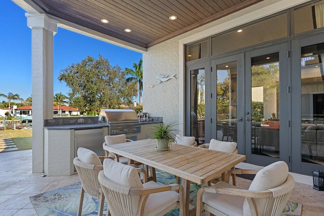 view of patio / terrace with area for grilling, french doors, and an outdoor kitchen