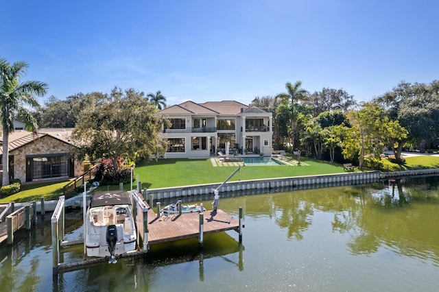 view of dock with a water view and a yard