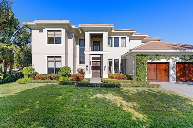 view of front facade featuring a front yard and a garage