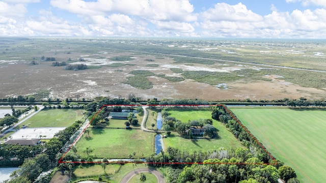 birds eye view of property with a rural view