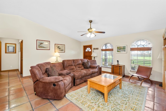 tiled living room with ceiling fan and vaulted ceiling