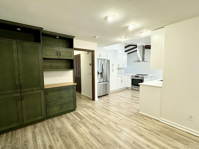 kitchen featuring light hardwood / wood-style flooring, wall chimney exhaust hood, stainless steel appliances, and a textured ceiling