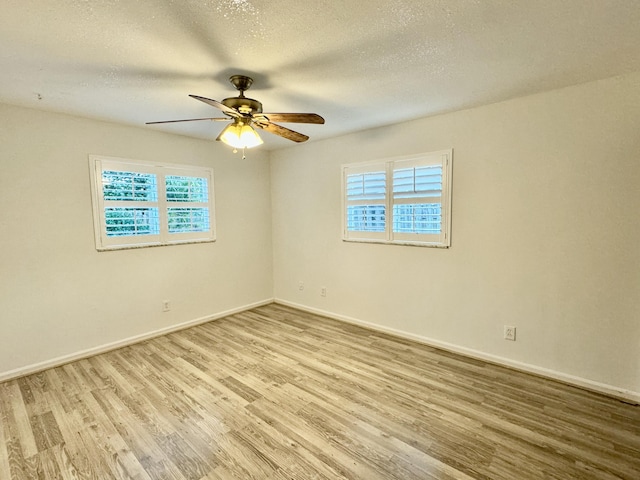 unfurnished room featuring a textured ceiling, light hardwood / wood-style floors, and ceiling fan