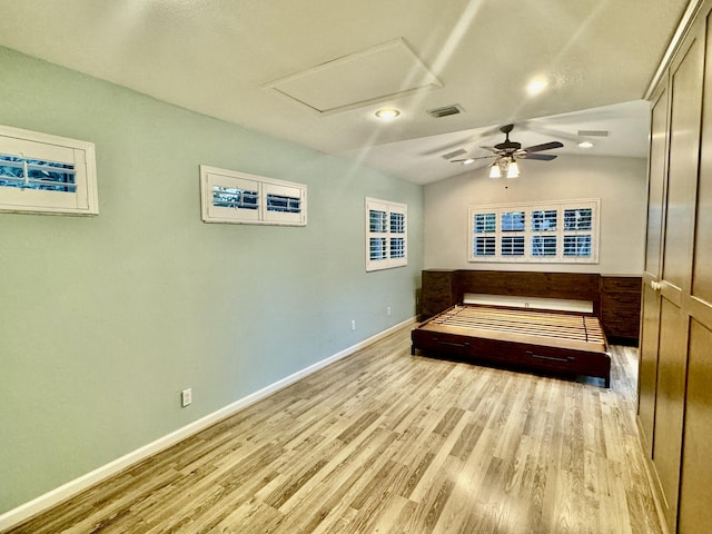 bedroom featuring ceiling fan, vaulted ceiling, and light wood-type flooring