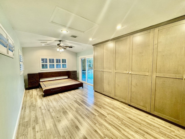 unfurnished bedroom featuring access to outside, light hardwood / wood-style flooring, and lofted ceiling