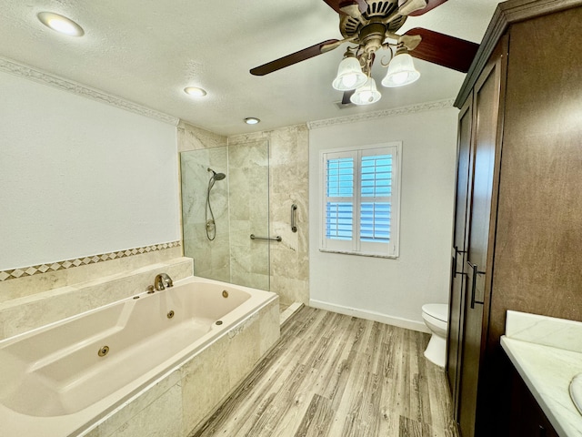 full bathroom with vanity, separate shower and tub, toilet, a textured ceiling, and wood-type flooring