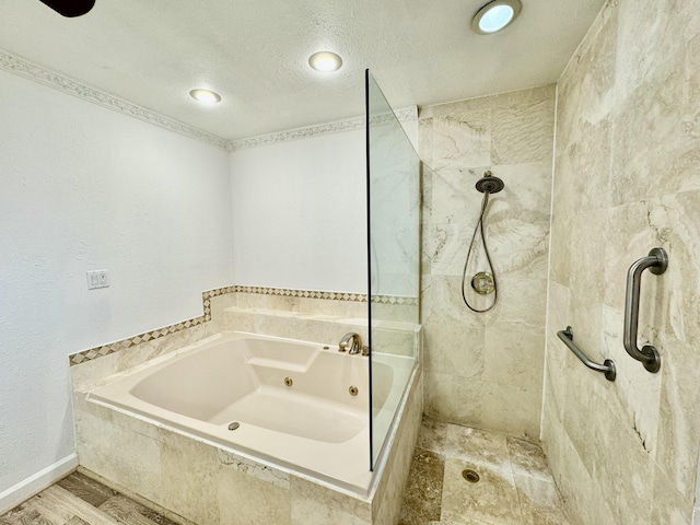 bathroom with plus walk in shower, wood-type flooring, and a textured ceiling