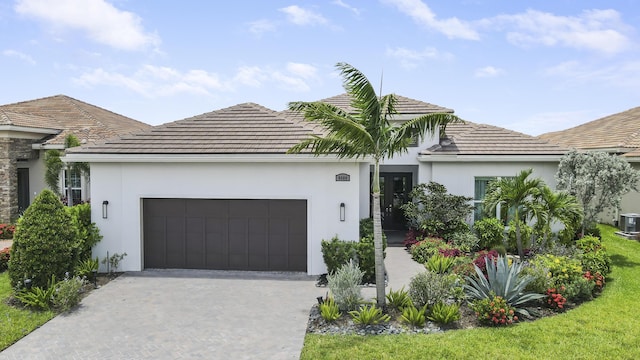 ranch-style house with a garage and cooling unit