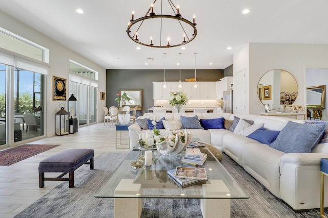 living room with a chandelier and light wood-type flooring