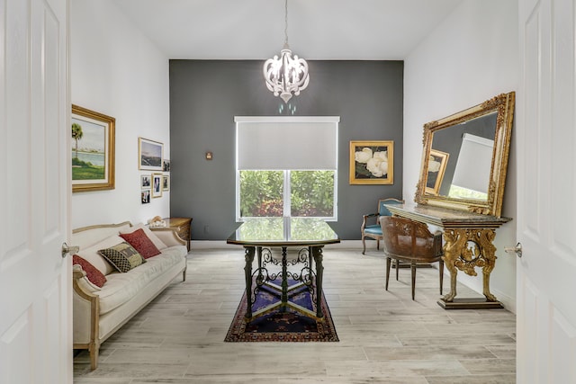 sitting room featuring an inviting chandelier and light hardwood / wood-style flooring