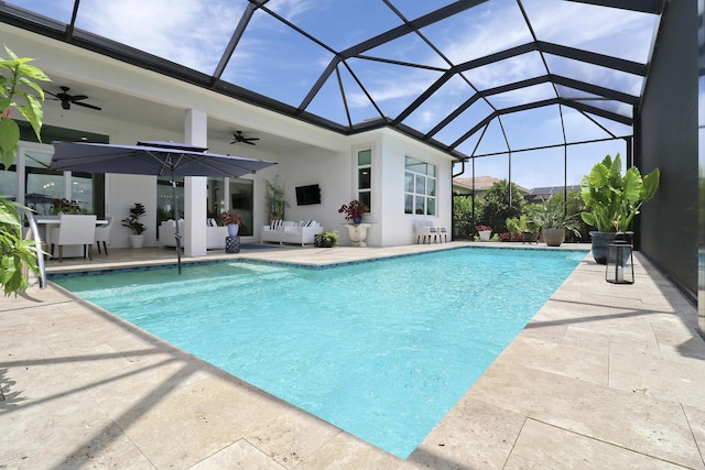 view of pool with a lanai, a patio, and ceiling fan