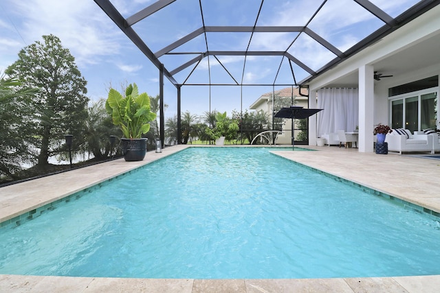 view of swimming pool with an outdoor hangout area, a patio, ceiling fan, and glass enclosure