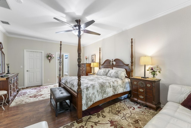 bedroom with ornamental molding, visible vents, dark wood finished floors, and a ceiling fan