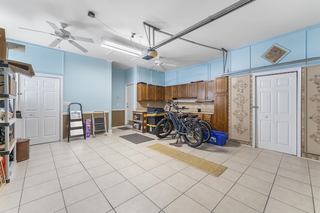 garage with a garage door opener and a ceiling fan