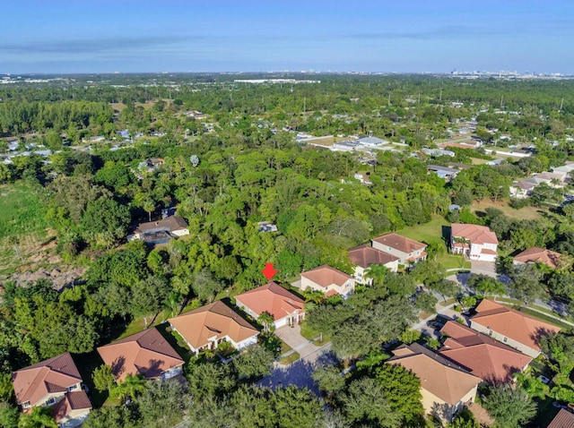 aerial view featuring a wooded view and a residential view