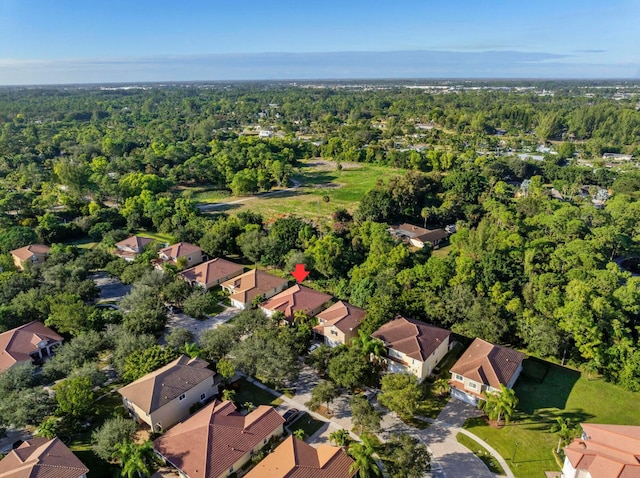 bird's eye view featuring a residential view and a wooded view