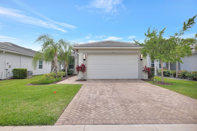 ranch-style home with a garage and a front yard